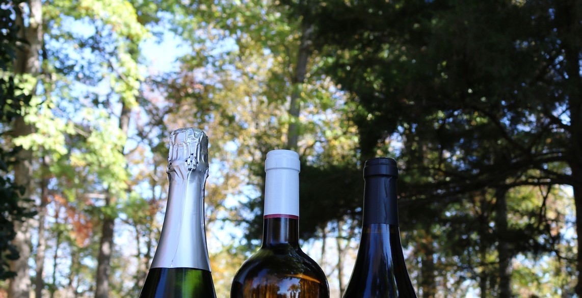 tops of three wine bottles